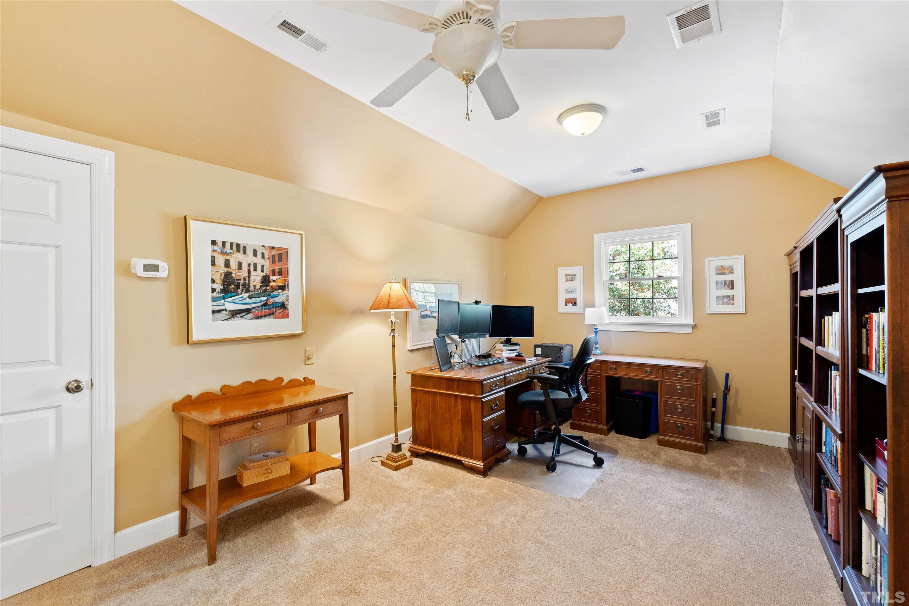 9429 Barton Creek Road Raleigh, NC 27615 - Photo 52 of 78 a view of a workspace with furniture and a window