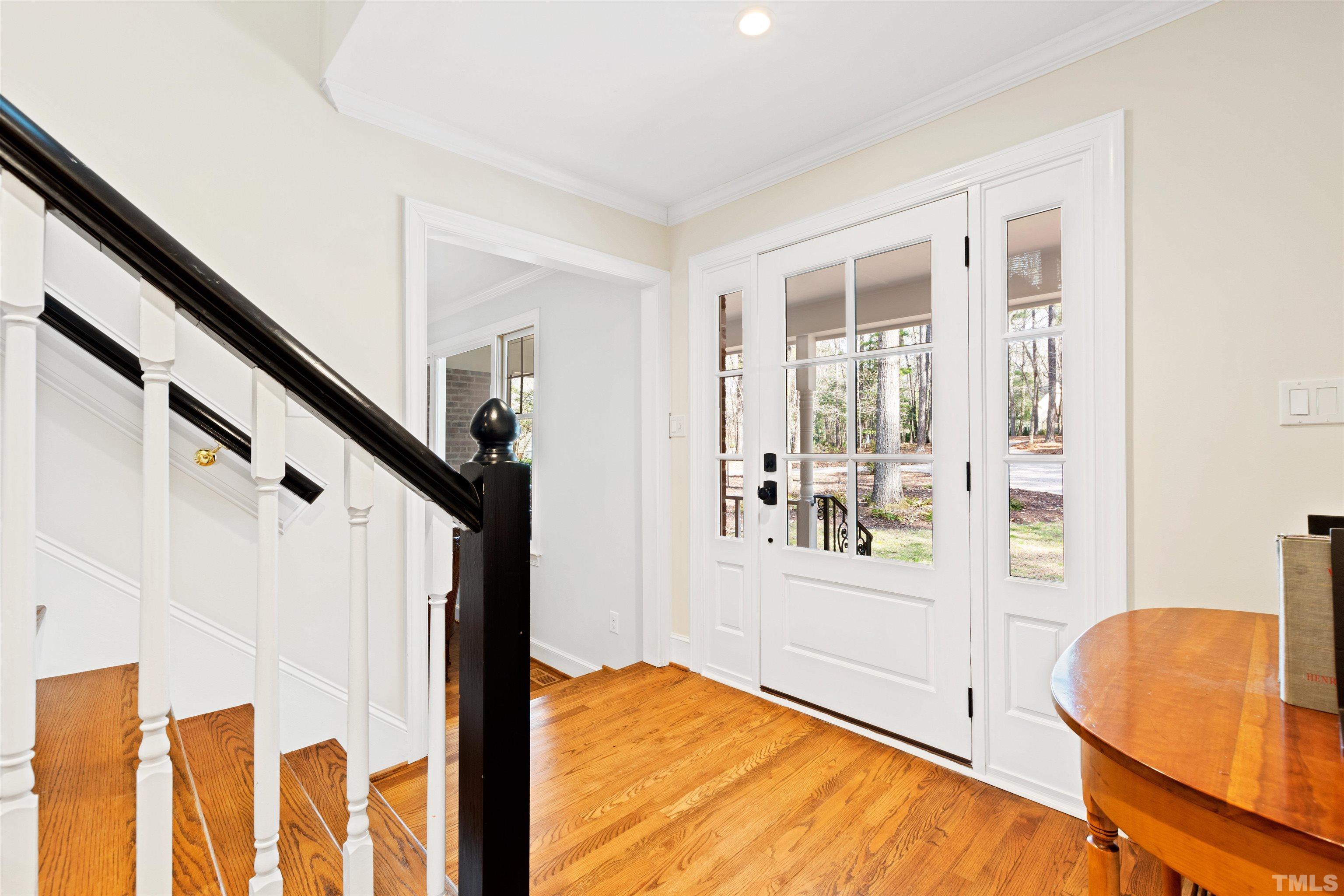 9429 Barton Creek Road Raleigh, NC 27615 - Photo 7 of 78 a view of an entryway with wooden floor and door