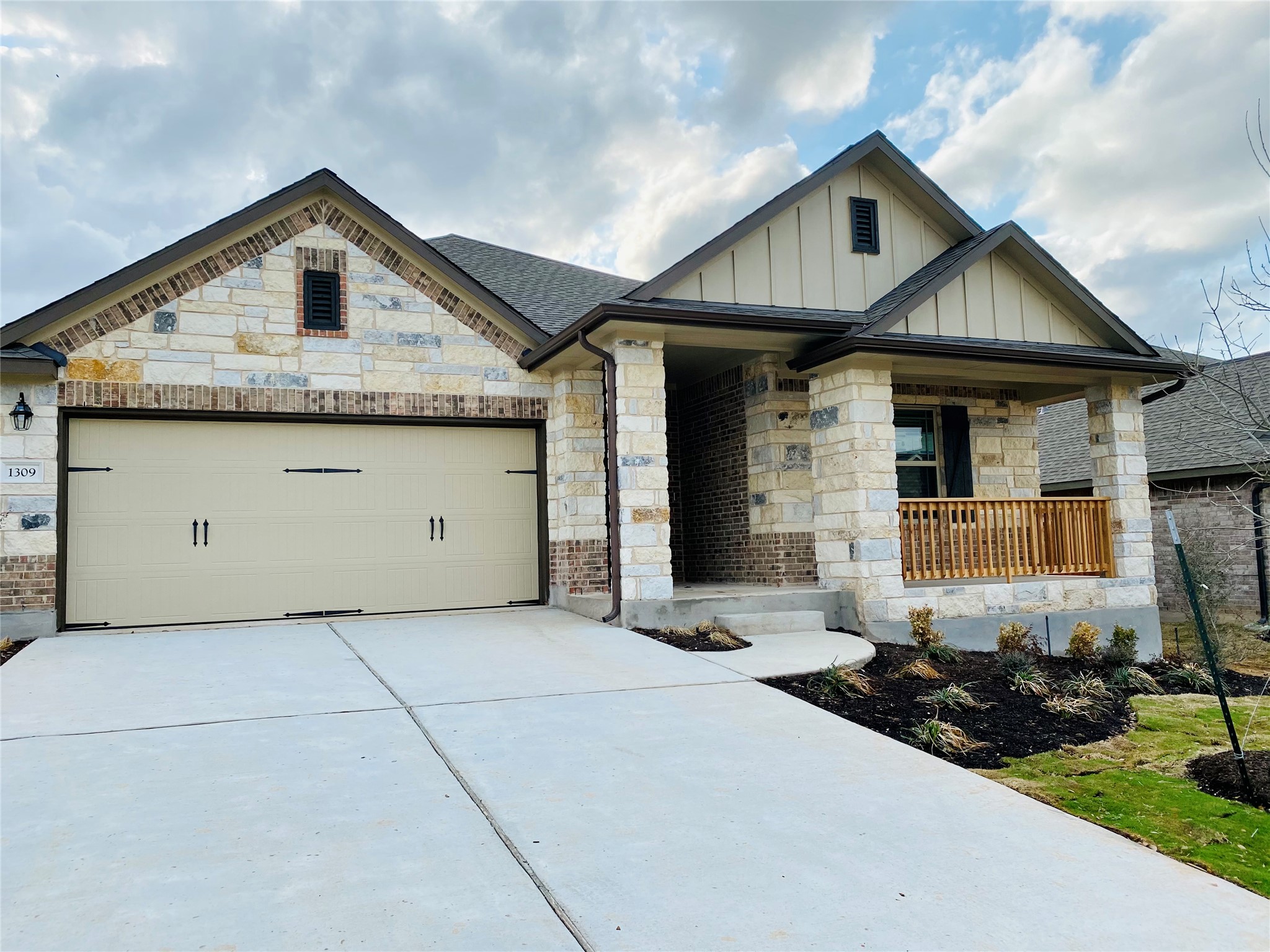 1309 Terrace View Georgetown, TX 78628 - Photo 4 of 36 A welcoming front facade showcases a blend of brick and stone, complete with an inviting porch and a well-maintained driveway.