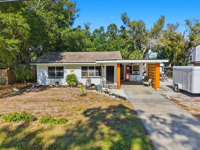 a view of a house with backyard sitting area and garden