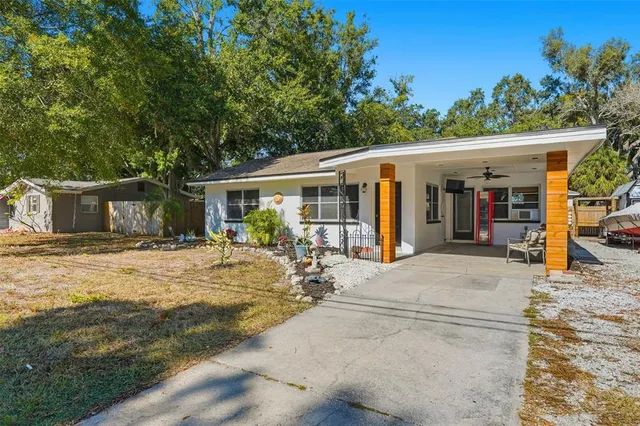 a backyard of a house with yard and outdoor seating