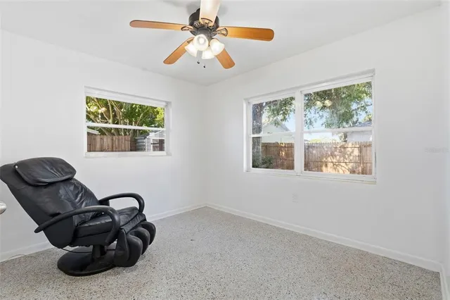 a backyard of a house with barbeque oven table and chairs