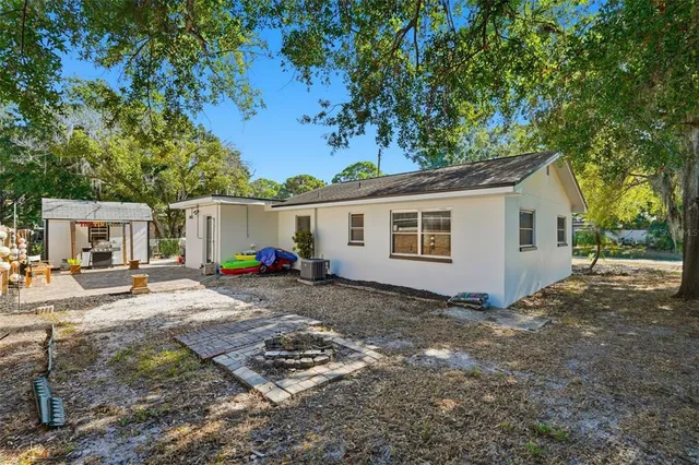 a wooden house with trees in front of it