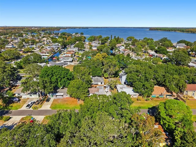an aerial view of residential houses with outdoor space and street view