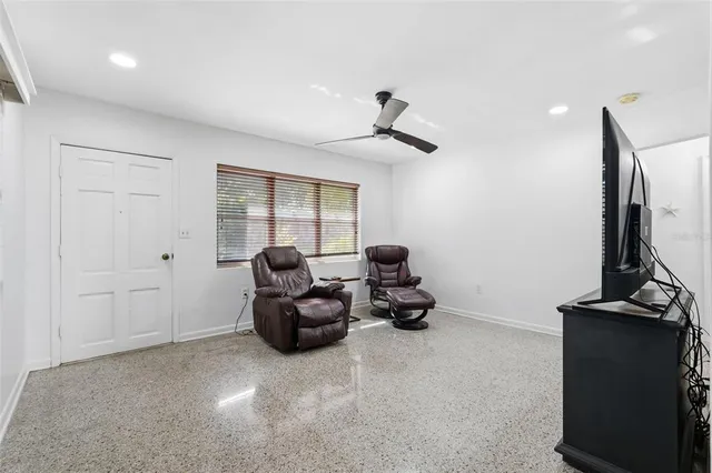 a kitchen with granite countertop white cabinets stainless steel appliances and a window