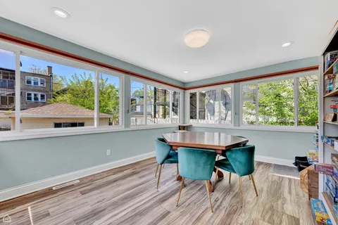 a dining room with furniture and a large window