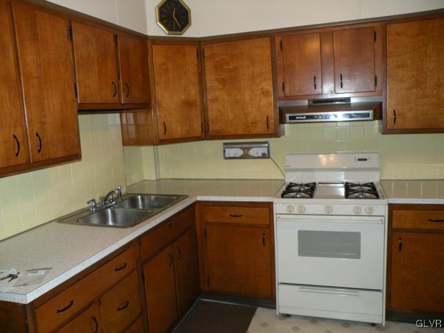 343 Broad Street Emmaus, PA 18049 - Photo 4 of 16 a kitchen with a sink a stove and cabinets