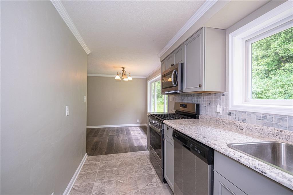 321 Logan Road Imperial, PA 15126 - Photo 2 of 24 New kitchen open to dining room. Stainless appliances, new counters and back splash. Large window for lots of natural light.
