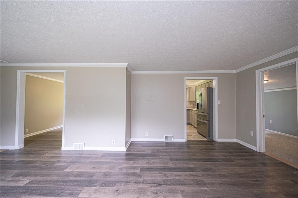 321 Logan Road Imperial, PA 15126 - Photo 7 of 24 Living room view....door to left enters dining room, middle door to kitchen, door to right leads to newly added bedroom.