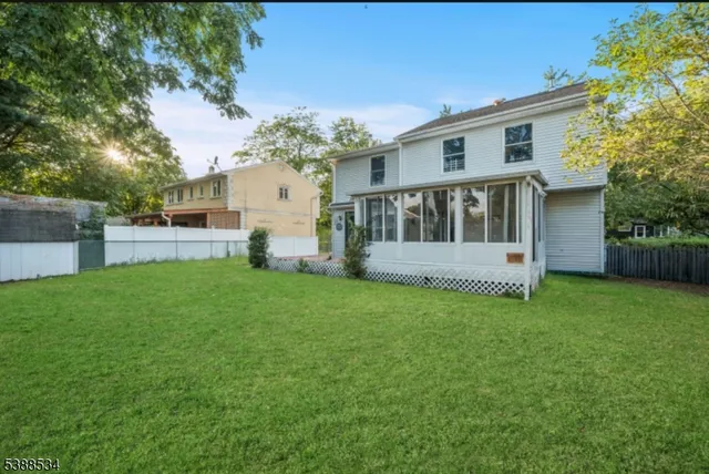 a view of a house with backyard and a garden