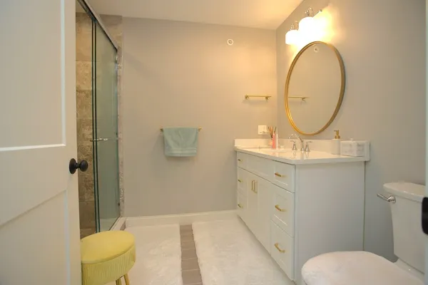 a bathroom with a toilet sink and mirror