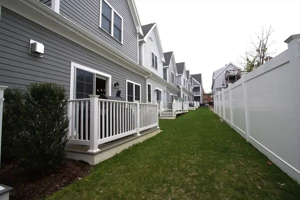 a view of a house with a yard and deck