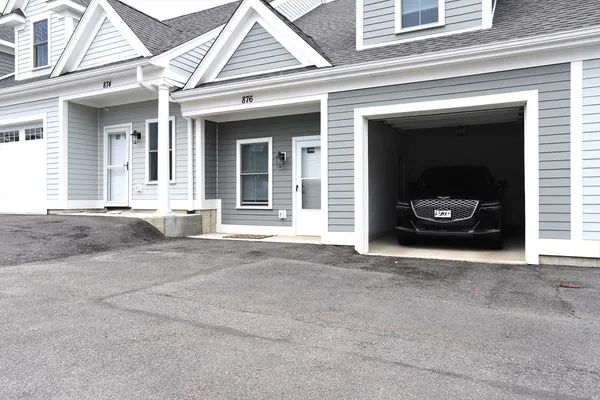 a view of a car parked front of a house