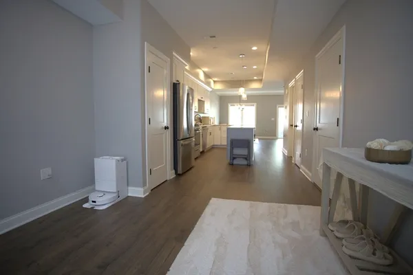 a view of a big room with wooden floor and windows