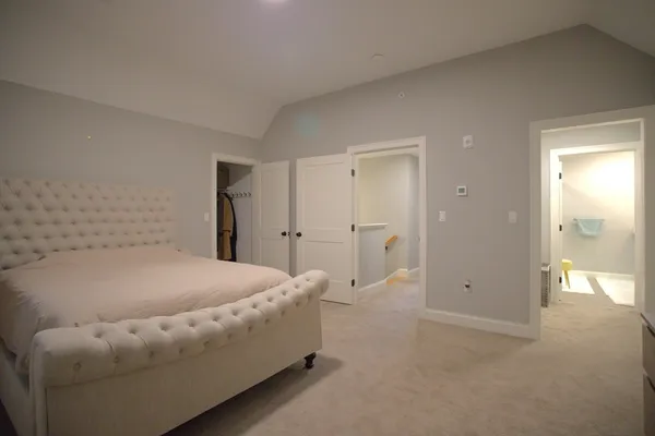 a room with a bed and a chandelier