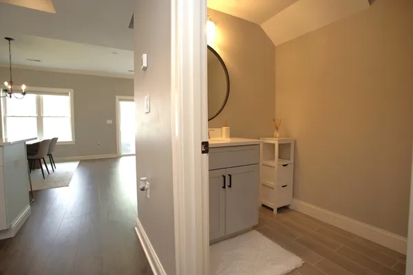 a view of a hallway and a livingroom with furniture