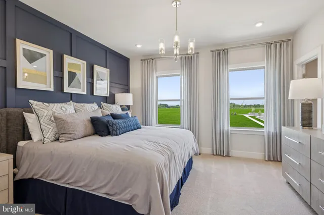 a spacious bedroom with a bed and a large window