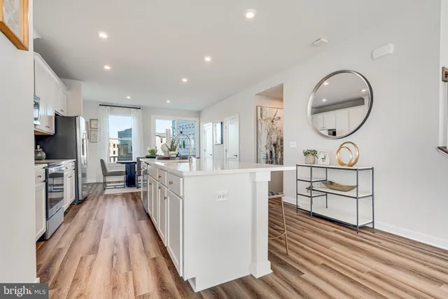 a view of kitchen with sink and wooden floor