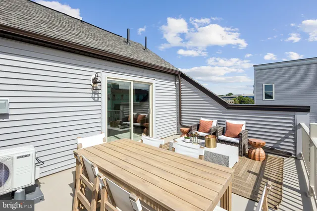 a backyard of a house with table and chairs