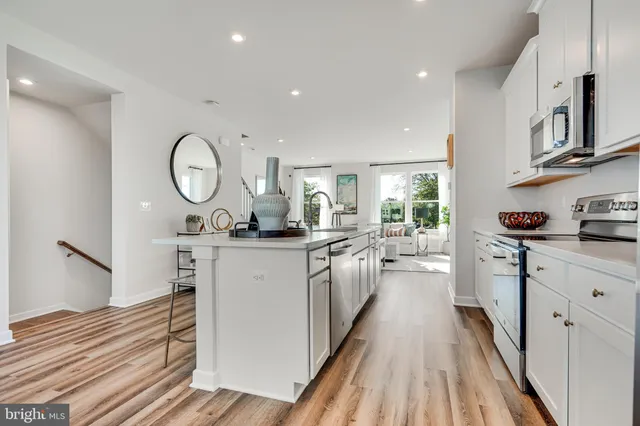 a kitchen with sink cabinets and refrigerator