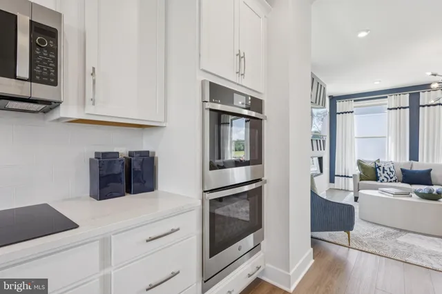 a kitchen with stainless steel appliances granite countertop a refrigerator and cabinets
