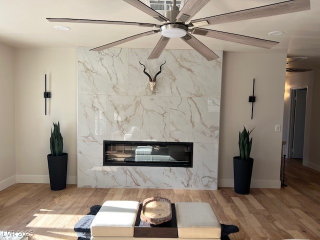 2712 Rialto Road Las Vegas, NV 89108 - Photo 35 of 54 Living area featuring a premium fireplace, a ceiling fan, wood finished floors, and recessed lighting