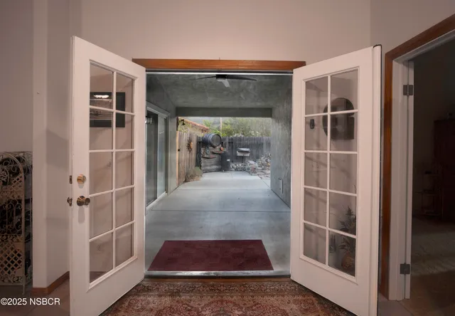 a view of a hallway with wooden floor and windows