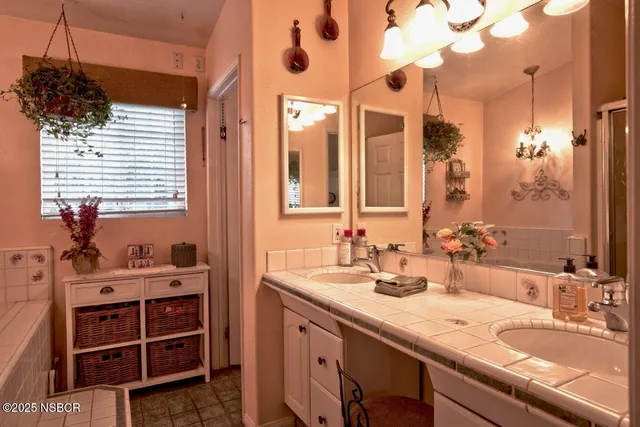a bathroom with a sink double vanity and a mirror