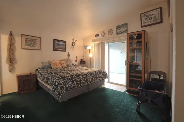 a bedroom with a bed and a desk