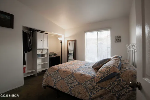 a bedroom with a bed and a television