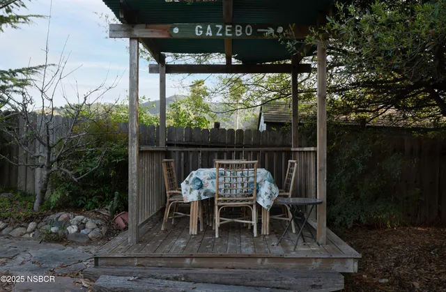 a view of balcony with wooden floor and outdoor seating