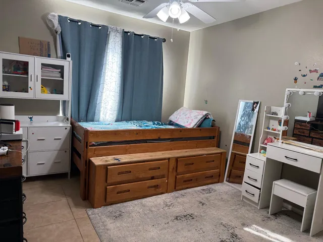 a room with a baby bed furniture and a window