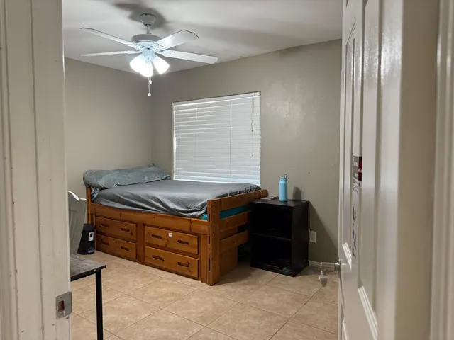 a room with a cabinet and a chandelier