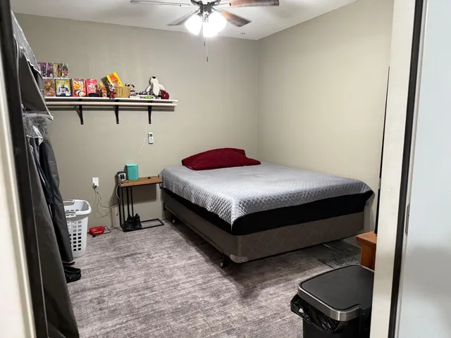 a bedroom with a bed and a table in it