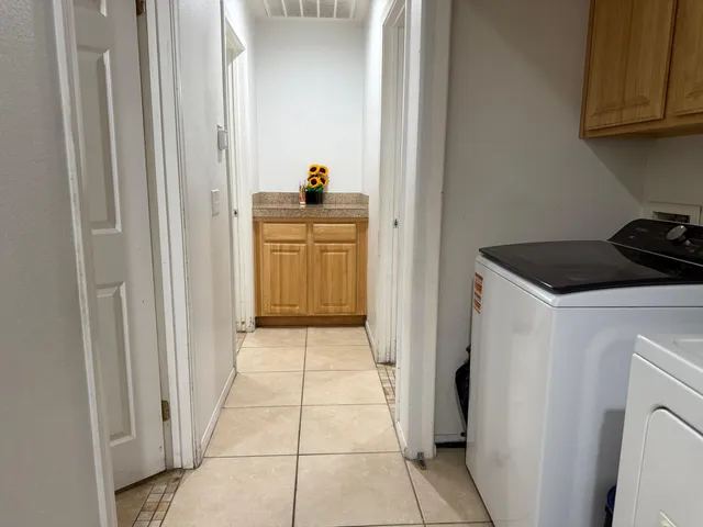 a kitchen with a refrigerator and cabinets