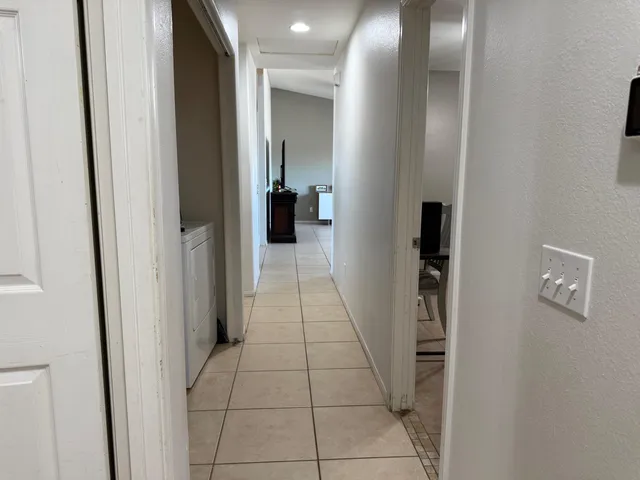 a view of a hallway with a bathroom