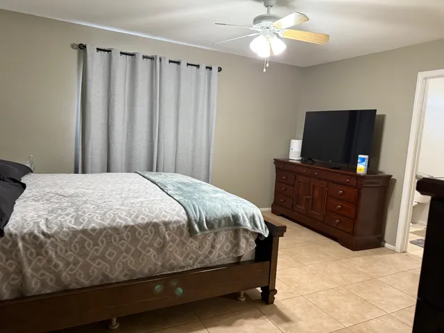 a bedroom with a bed and a television