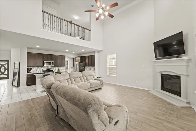 a living room with furniture fireplace and flat screen tv
