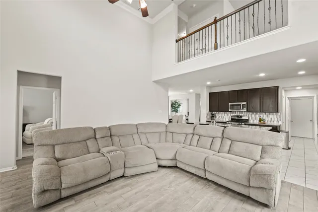 a living room with furniture and a view of bedroom