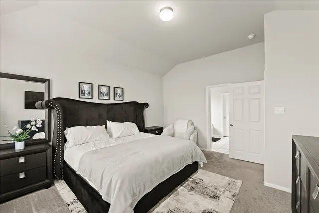 a bedroom with a bed and lamp