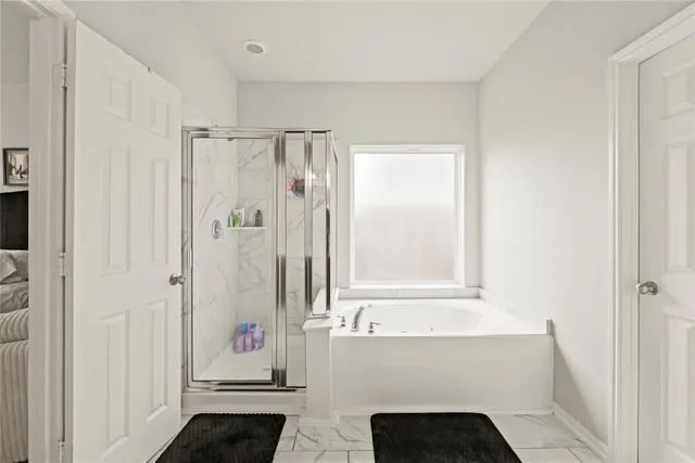 a bathroom with a bathtub and a shower