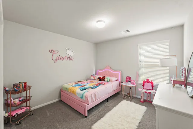 a bedroom with a bed and a table