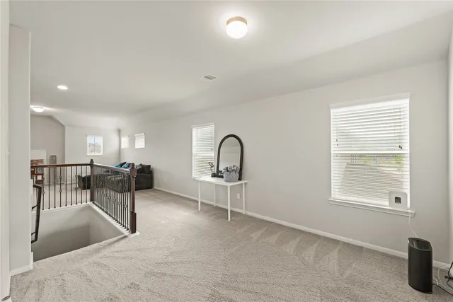 a view of a livingroom with furniture and a window