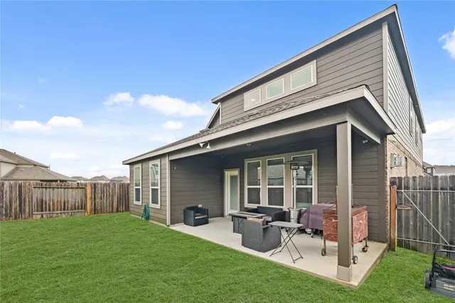 a backyard of a house with table and chairs