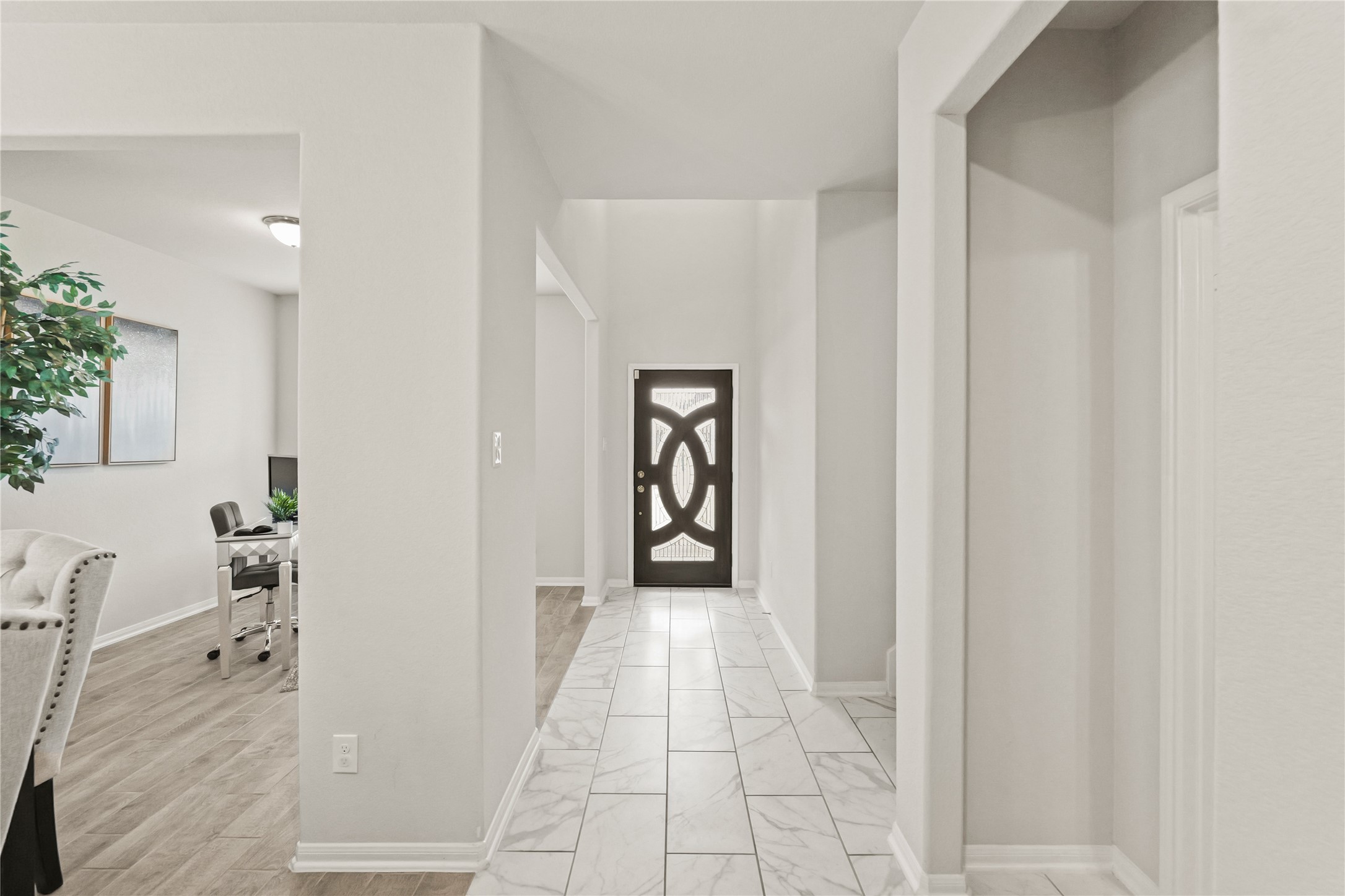 11107 Larkspur Dale Houston, TX 77044 - Photo 6 of 36 a view of a hallway with wooden floor and windows