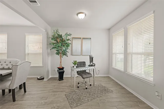 a living room with furniture a window and a potted plant