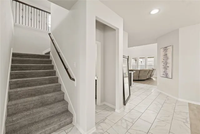 a view of entryway with bedroom and stairs