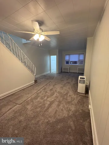 a view of a livingroom with a ceiling fan and a window