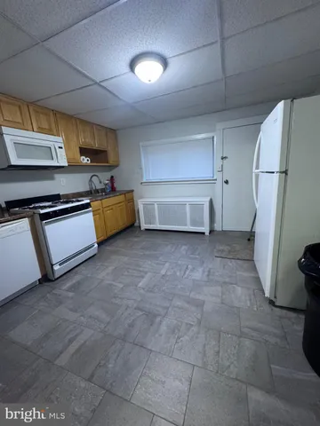 a kitchen with stainless steel appliances granite countertop a refrigerator and a stove