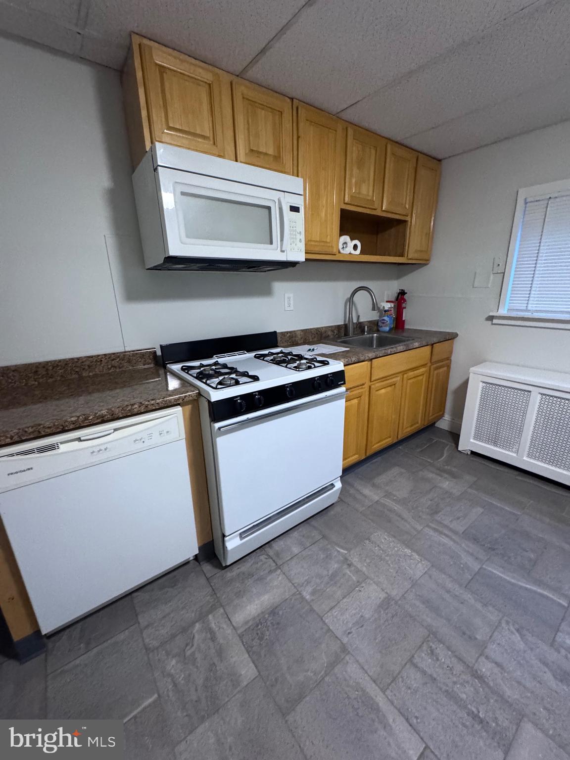 1031 Cantrell Street Philadelphia, PA 19148 - Photo 5 of 10 a kitchen with stainless steel appliances granite countertop a stove a sink and a microwave